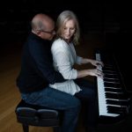 Anne and Dave sitting together at the piano