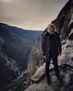 Anne standing on the edge of a cliff in Yosemite National Park